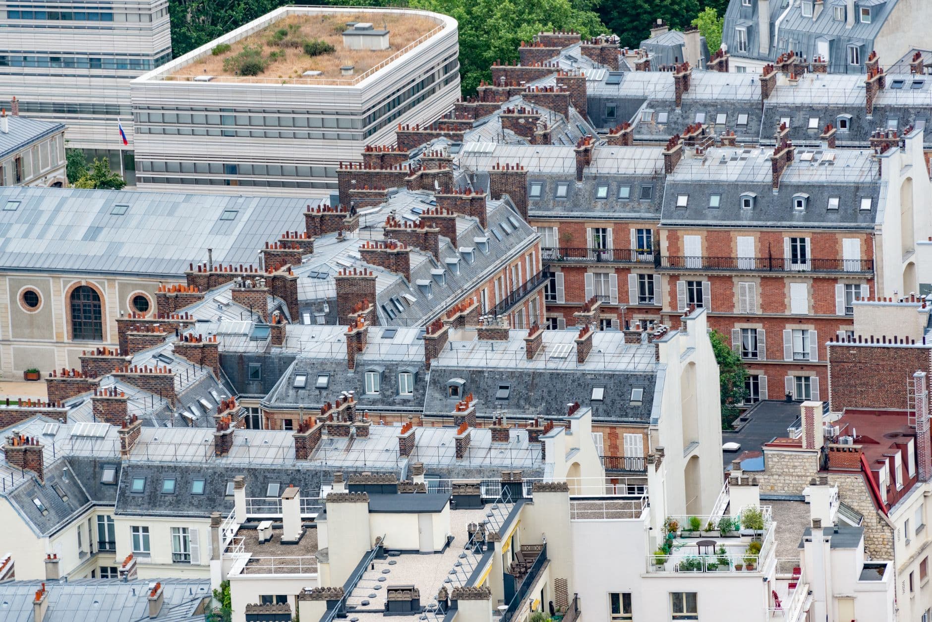 Charming aerial view of traditional Parisian rooftops showcasing classic French architecture.